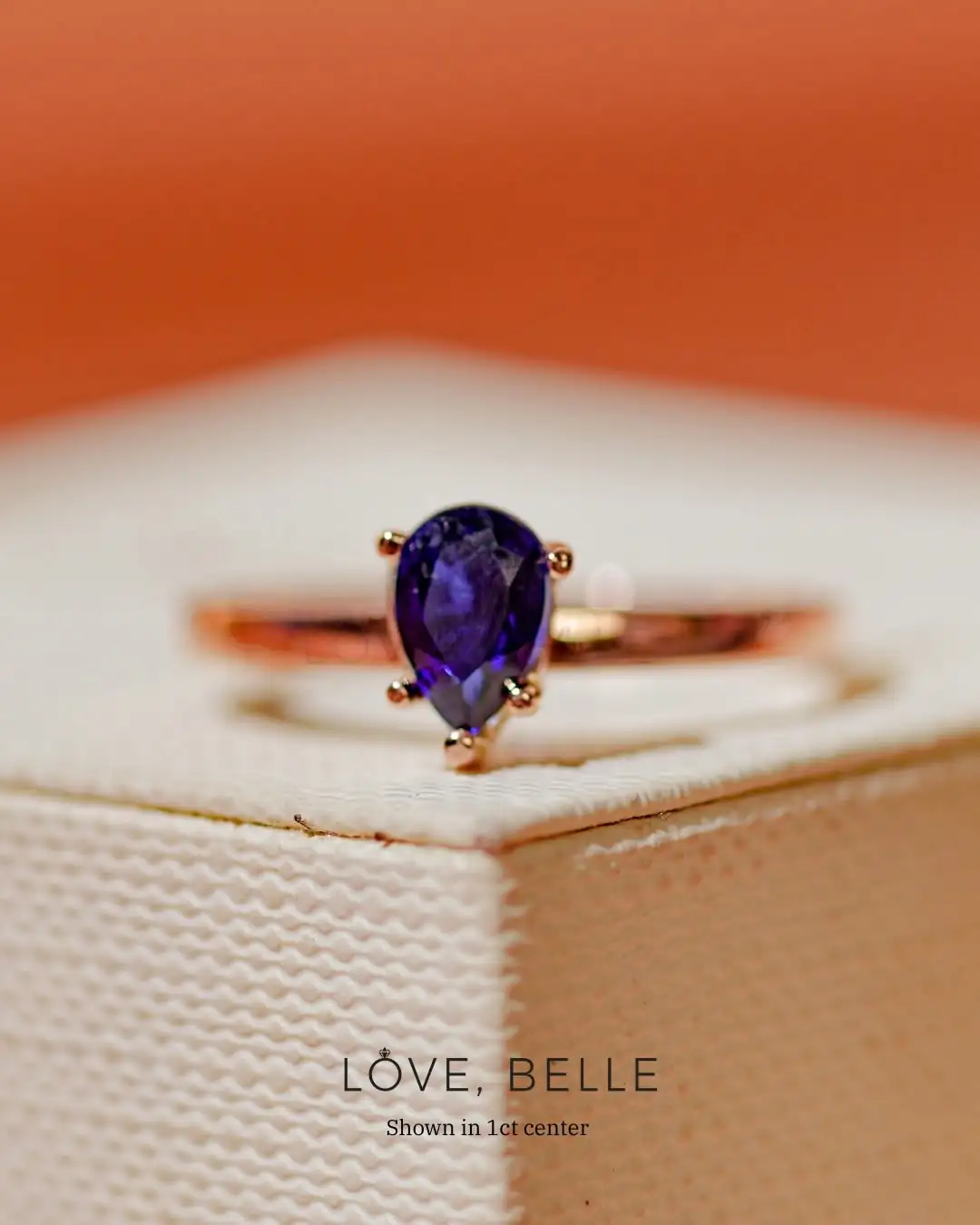 A pear-cut ring with a coloured centre stone
