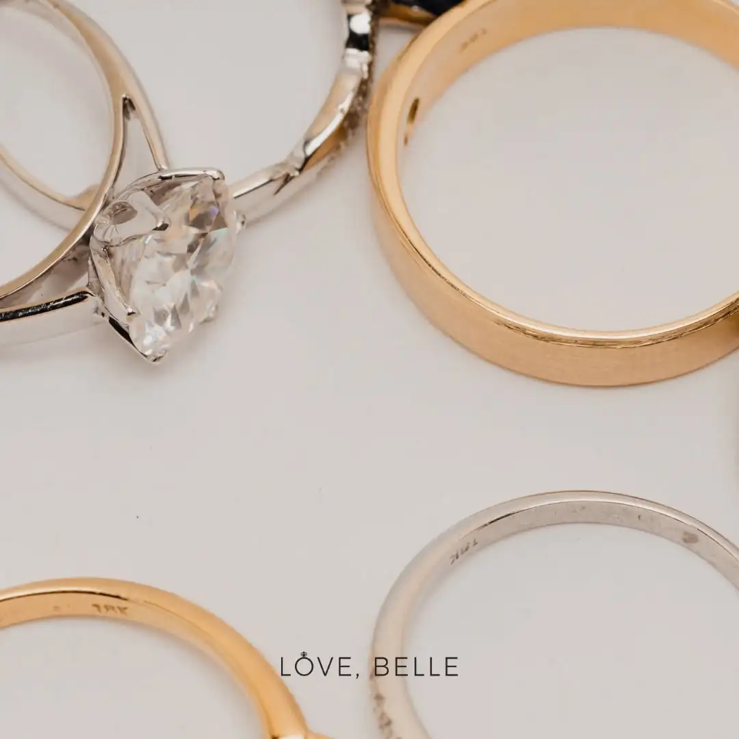 A flat-lay of solid gold rings showing their karat stamps